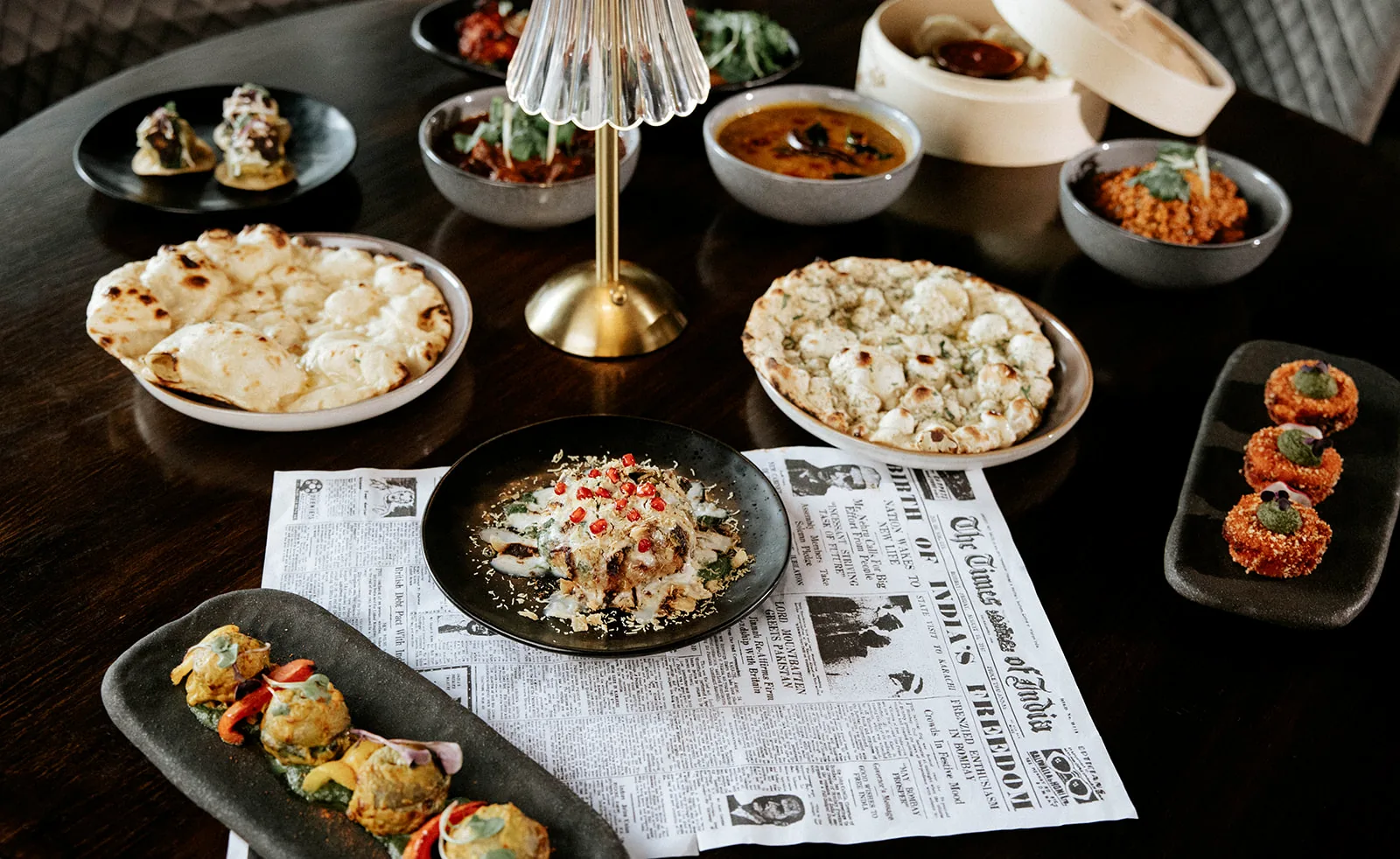 A shared spread of Indian dishes, breads and small plates at Times of India Auckland CBD